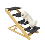 Small white fluffy dog climbing adjustable wooden pet stairs with black non-slip carpet steps.
