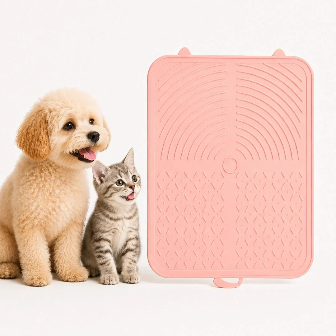 Fluffy puppy and tabby kitten posing beside a pink Petifo silicone pet lick mat
