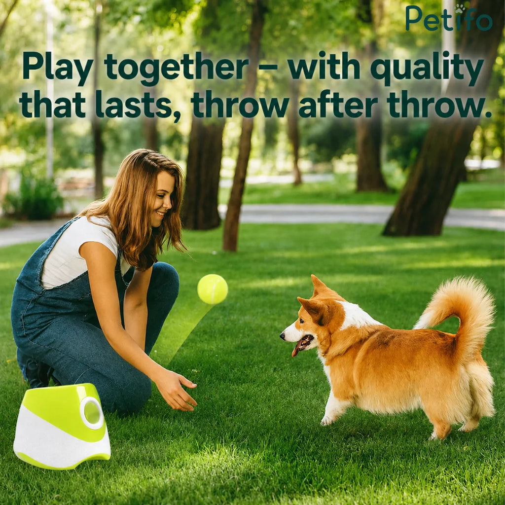 woman playing with her dog in a green park using a portable green automatic ball launcher to throw tennis balls