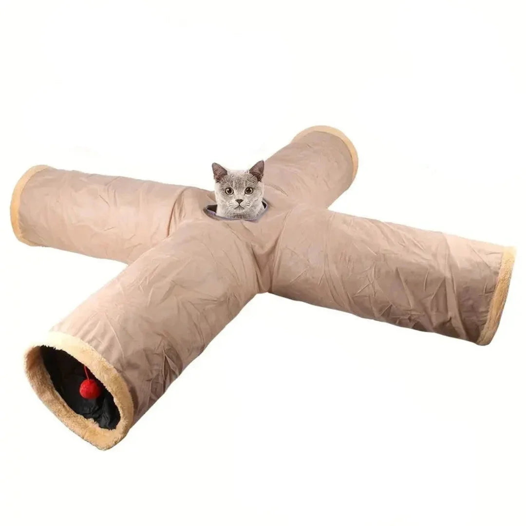 Four-way X-shaped beige cat tunnel toy with a grey cat looking through the center opening.